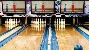 Bowling lanes with screens above the lanes