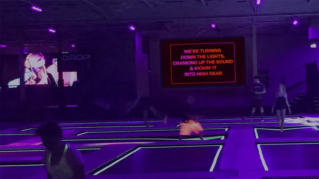 A digital sign on a TV in a trampoline park