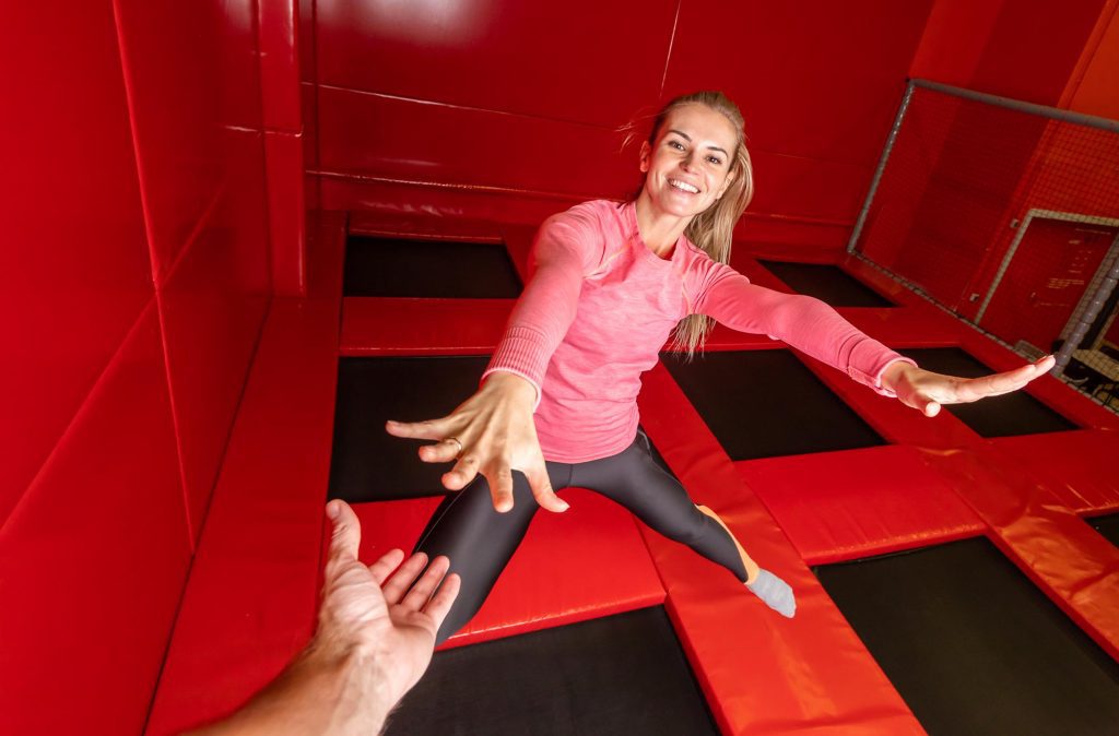 Woman jumping in trampoline park