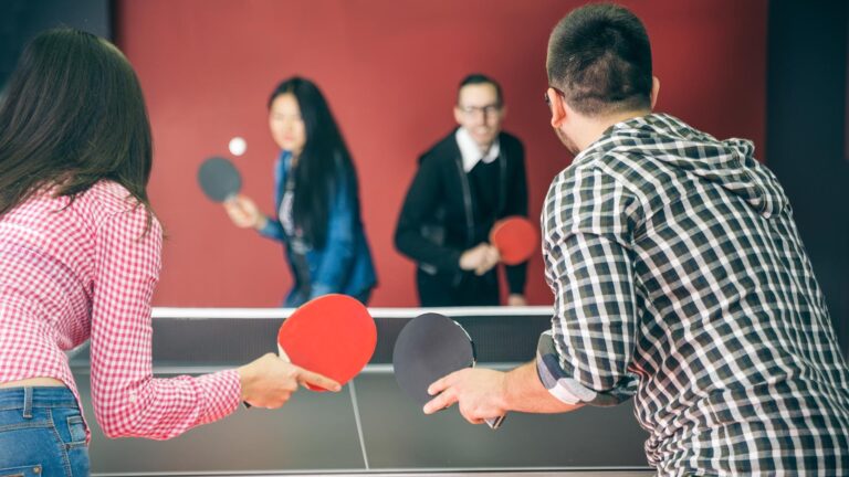 Two young couples playing table tennis