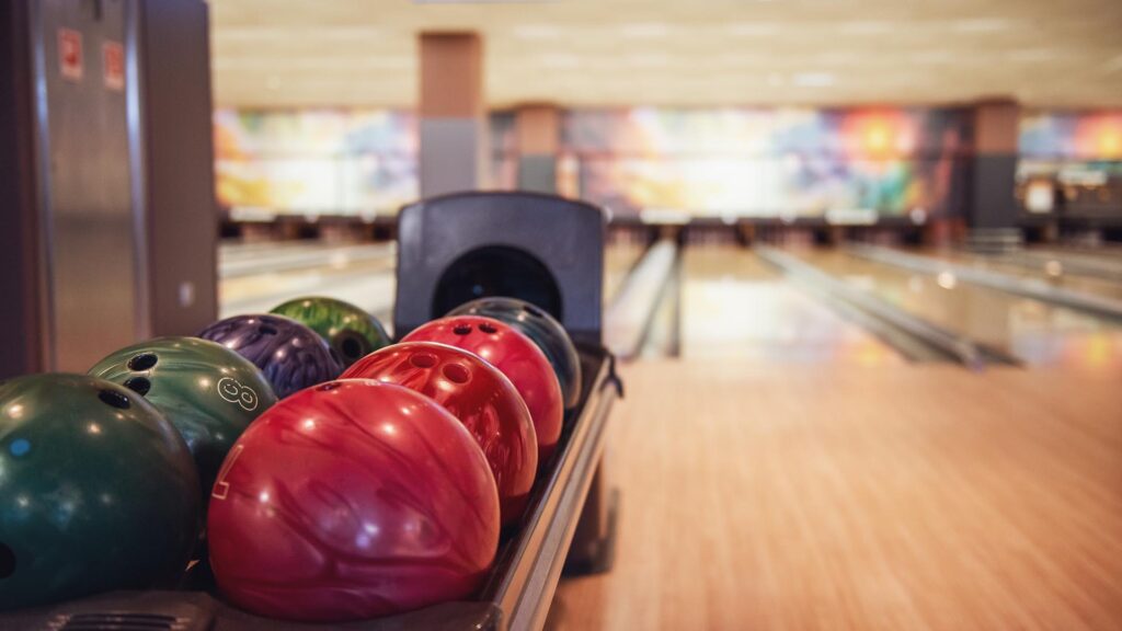 Empty Bowling lane with balls in the rack