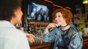 Women discussing at bar