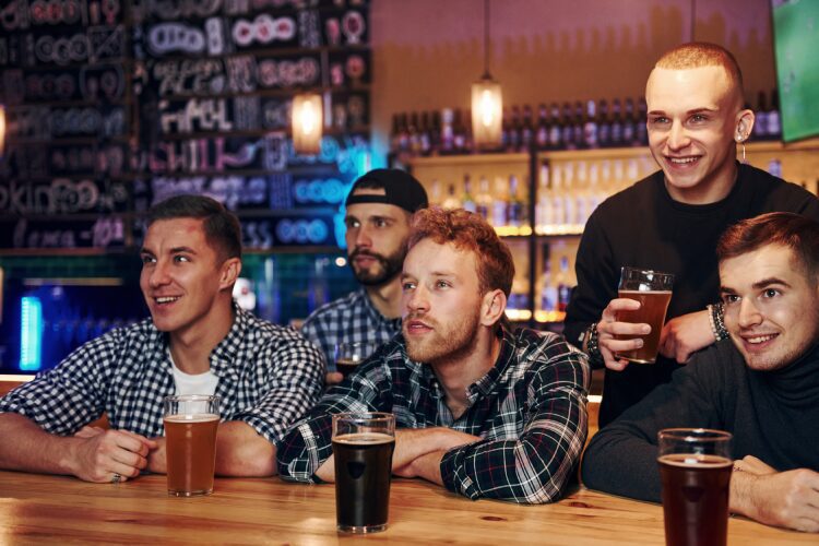 People watching a game at the bar